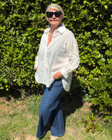 chemise coupe loose blanche avec broderies et sequins au niveau des manches, pate de boutonnage. Convient pour une taille 44 au 48