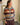 Gilet à larges rayures Johanna Paris, coloris gris, rouille, beige et prune, porté de face.