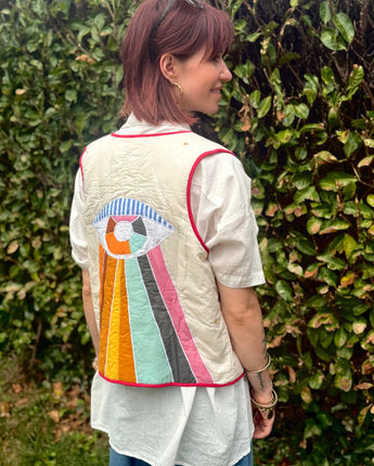 gilet sans manches légèrement matelassé, oeil arc en ciel multicolore brodé, petits boutons devant, marque The Corner, idéale avec la chemise flower brodée de la même marque