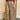 Pantalon jupe-culotte Johanna Paris à carreaux beige et bordeaux, coupe ample avec ceinture camel à boucle dorée.