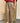 Pantalon jupe-culotte Johanna Paris à carreaux beige et bordeaux, coupe ample avec ceinture camel à boucle dorée.