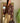 Veste courte en daim chocolat à œillets dorés LM Lulu Créatrice portée avec pantalon beige