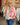 Veste brodée réversible rose Johanna Paris avec broderies florales multicolores portée en boutique MC by Chloé Ronchin.