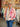 Veste brodée réversible rose Johanna Paris avec broderies florales multicolores portée en boutique MC by Chloé Ronchin.